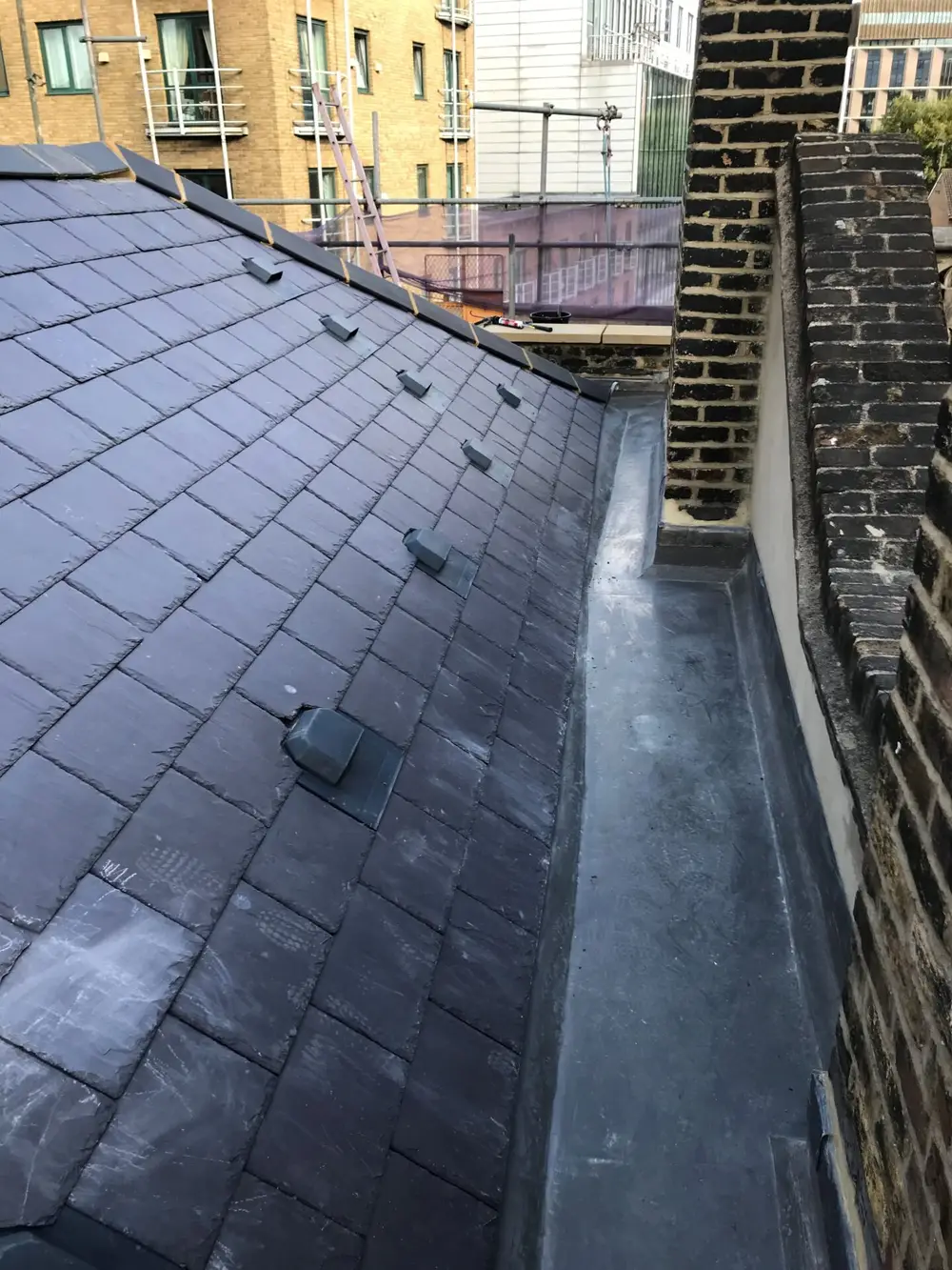 Slate roof with a new lead-lined gutter